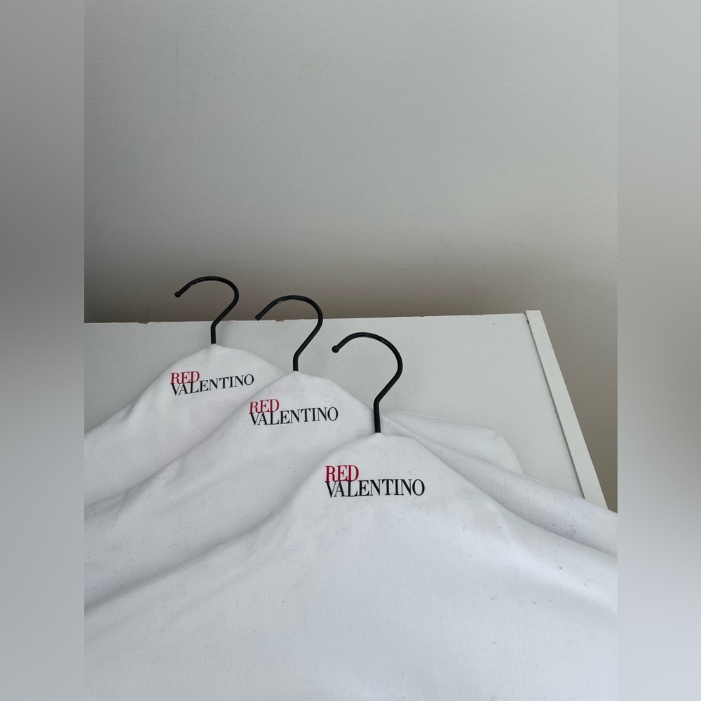 Three Red Valentino hangers. Cloth over plastic hangers. Very good condition.